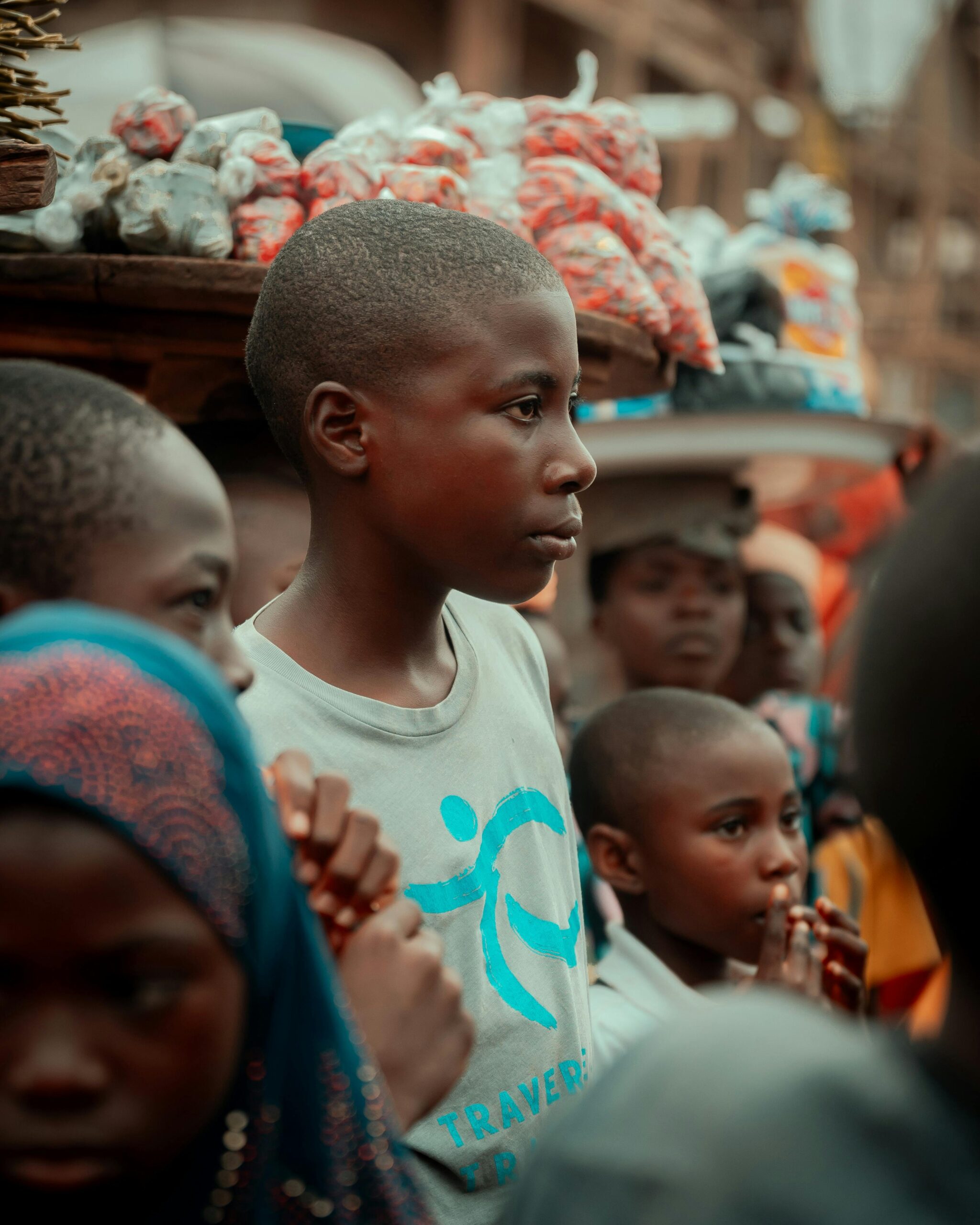 Children in a bustling street market in Ife, Nigeria. Vibrant cultural scene.